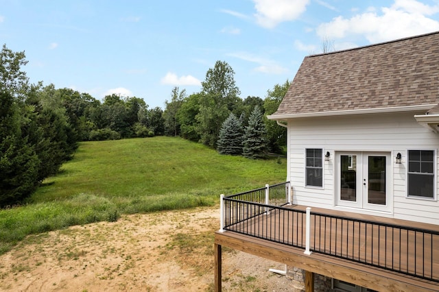 view of yard featuring a wooden deck and french doors