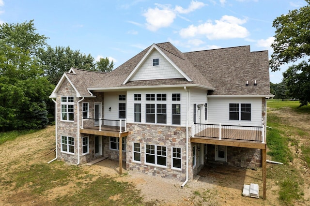 back of house featuring a lawn and a deck