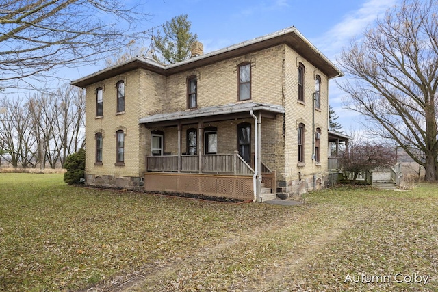 view of front of property with covered porch and a front yard