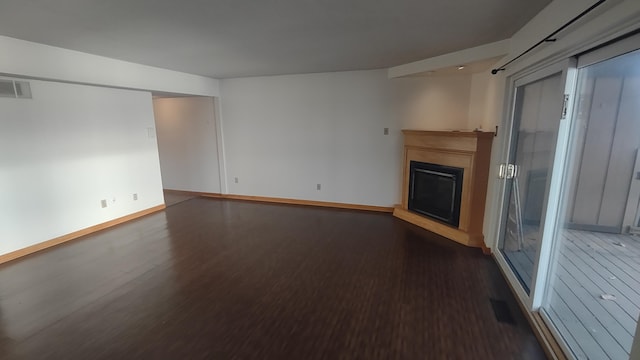 unfurnished living room featuring dark wood-type flooring