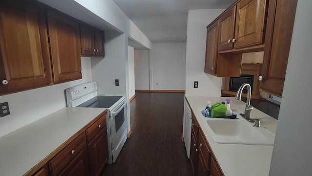 kitchen with white appliances, sink, and dark wood-type flooring