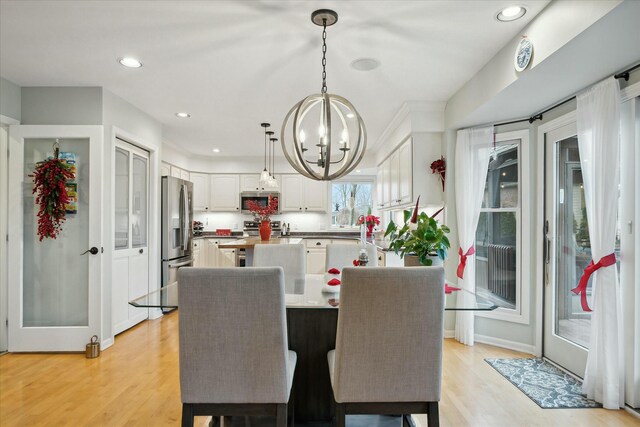 dining room featuring light hardwood / wood-style floors and an inviting chandelier