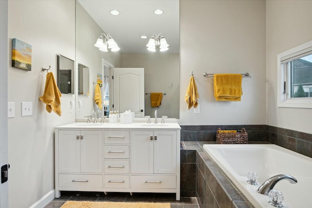 bathroom featuring vanity and tiled bath