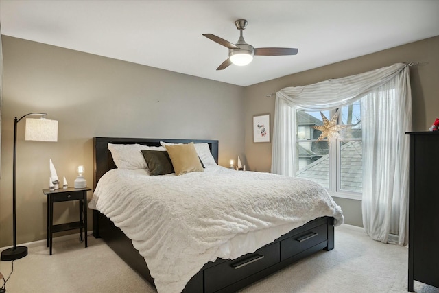 bedroom featuring ceiling fan and light carpet