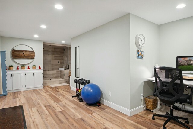 home office with light hardwood / wood-style flooring