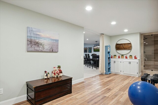 workout area with light wood-type flooring