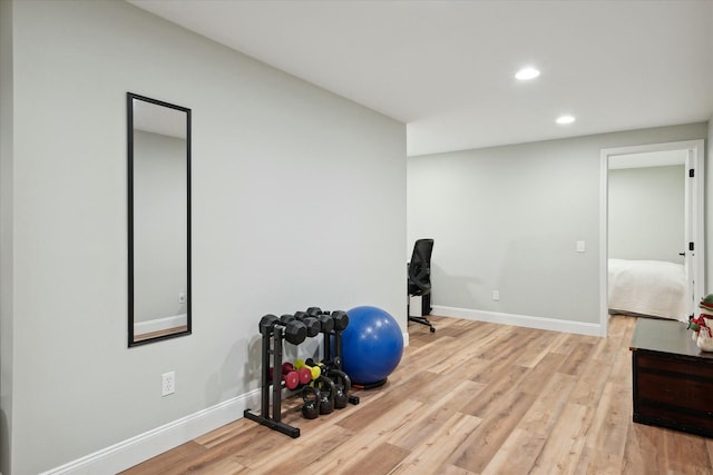 workout room with light hardwood / wood-style flooring