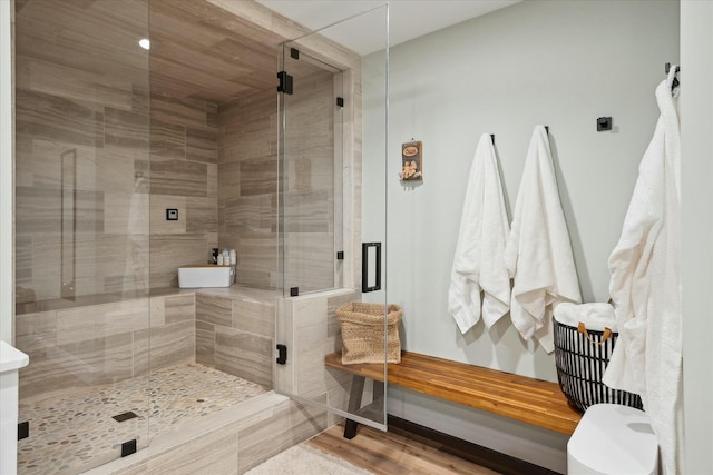 bathroom featuring an enclosed shower and hardwood / wood-style flooring