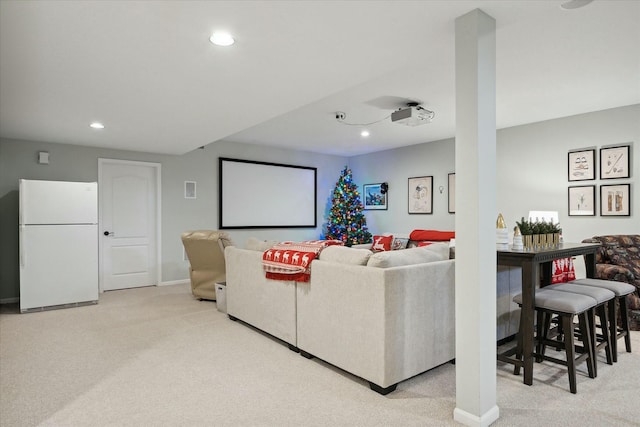 home theater room featuring light colored carpet