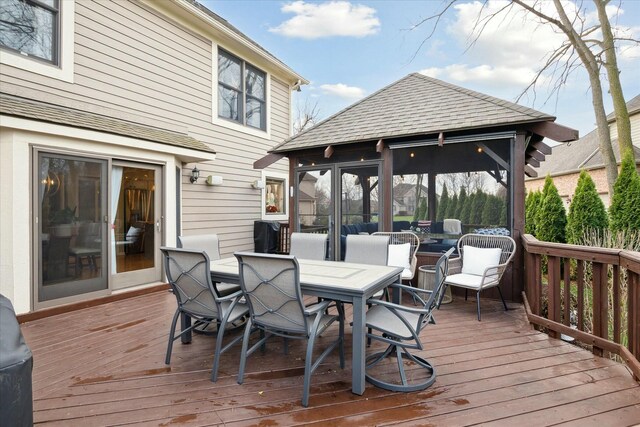 wooden terrace featuring a sunroom