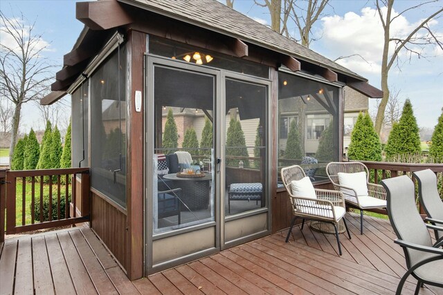 wooden terrace featuring a sunroom