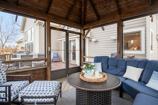 sunroom with lofted ceiling with beams and wooden ceiling