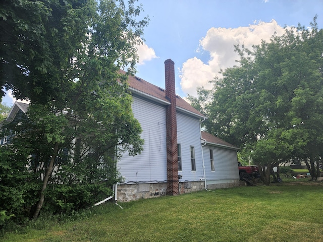 view of property exterior with a lawn