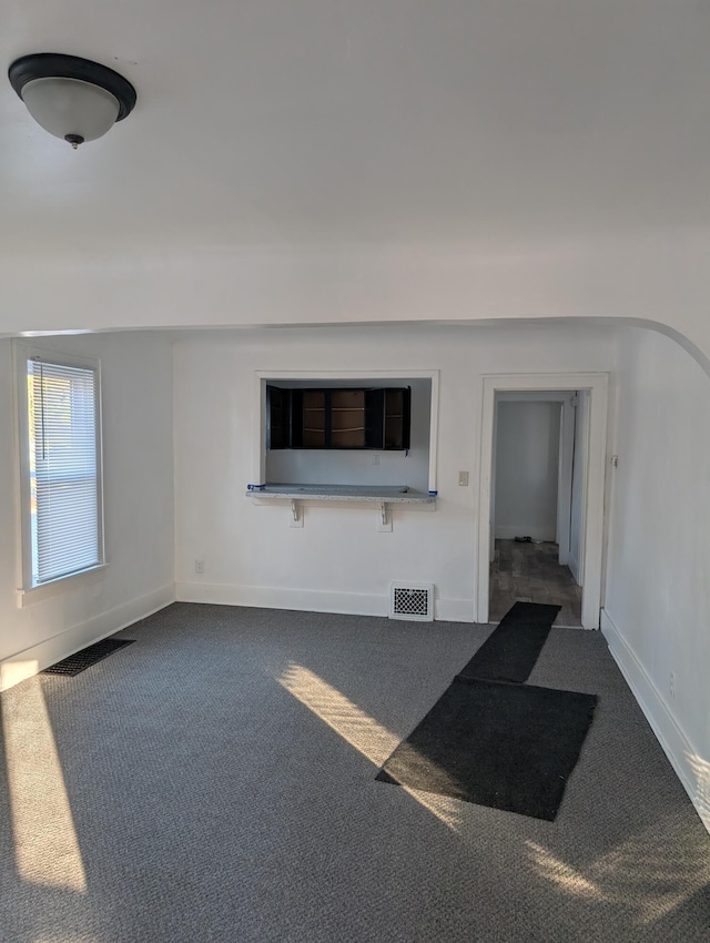 unfurnished living room with carpet flooring