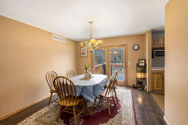 dining space featuring a chandelier and dark hardwood / wood-style floors