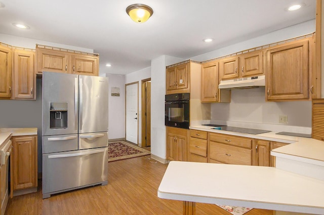 kitchen with black appliances and light wood-type flooring