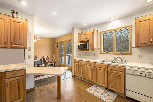 kitchen with white dishwasher, dark hardwood / wood-style floors, and sink