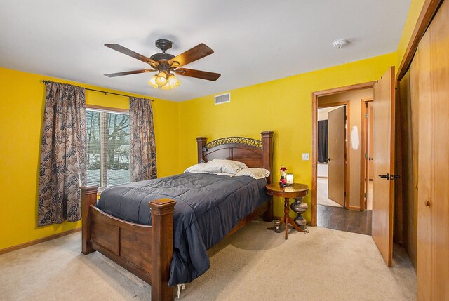 bedroom featuring ceiling fan and light colored carpet