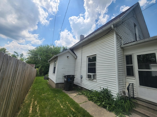 view of home's exterior with a yard and cooling unit