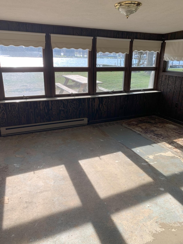 interior space featuring a healthy amount of sunlight, a water view, and a baseboard radiator