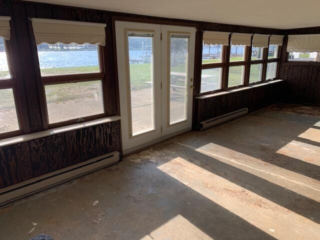 unfurnished sunroom with baseboard heating