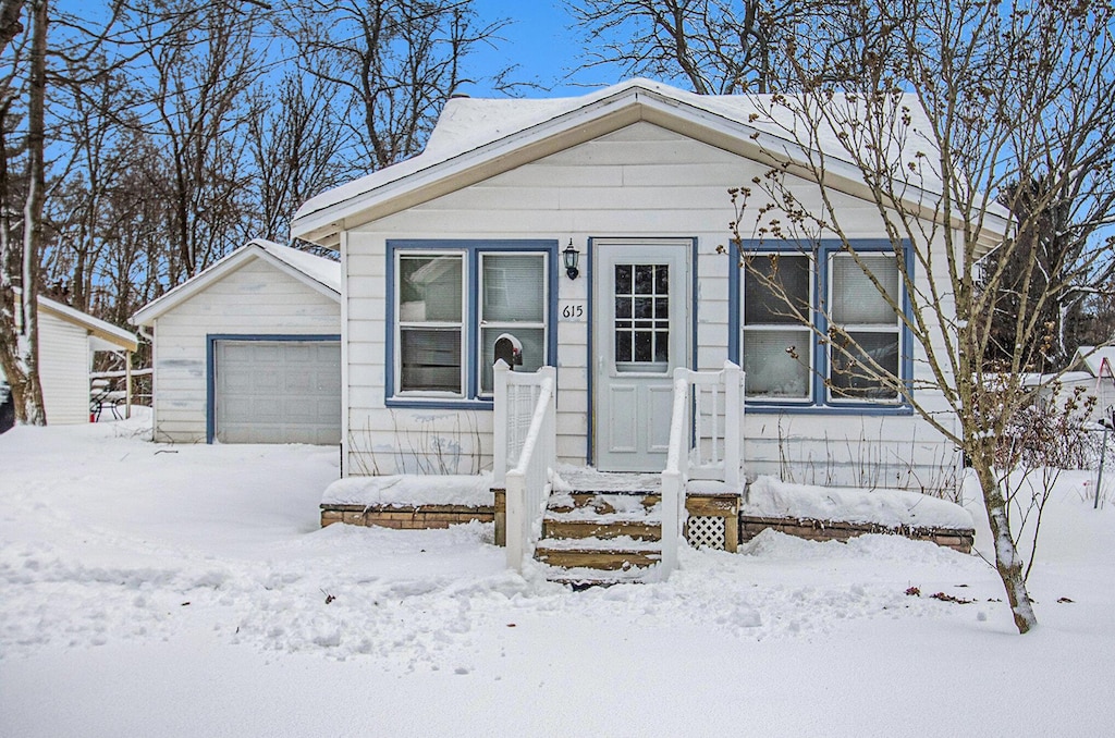 view of front of home with an outbuilding and a garage