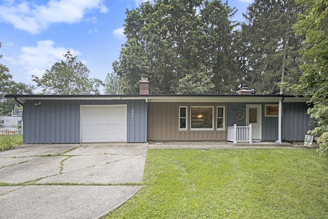 ranch-style home featuring a porch, a front yard, and a garage