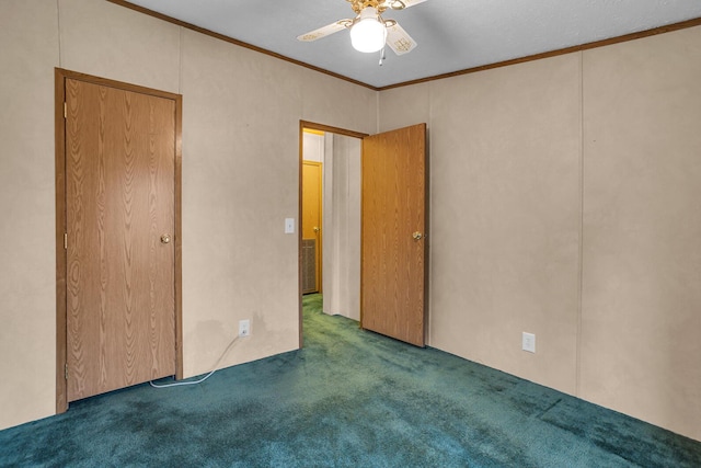 carpeted spare room with ceiling fan and ornamental molding