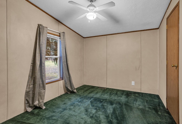 carpeted spare room featuring a textured ceiling, crown molding, ceiling fan, and lofted ceiling