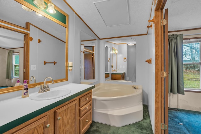 bathroom with vanity, a textured ceiling, a bathtub, and crown molding