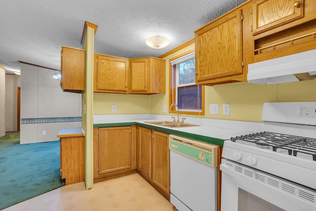 kitchen with a textured ceiling, white appliances, and sink