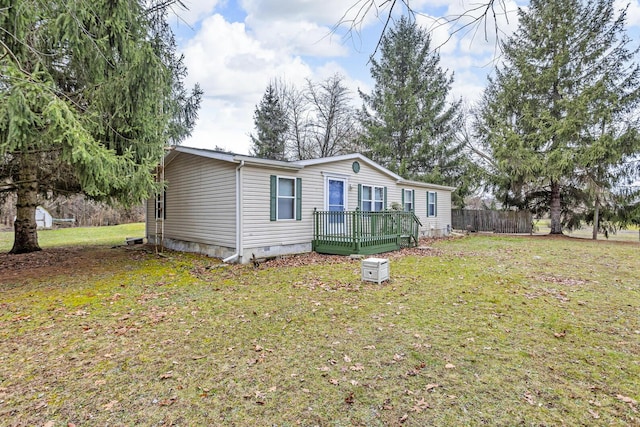 view of front of house with a wooden deck and a front yard