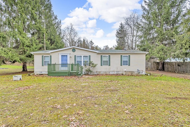 manufactured / mobile home featuring a front yard and a wooden deck