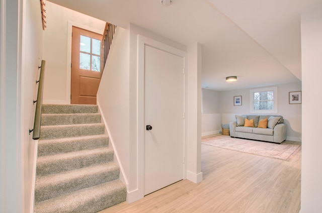 stairs featuring hardwood / wood-style flooring