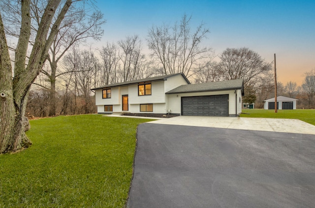 view of front facade featuring a garage and a lawn