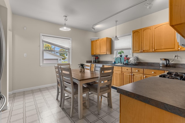 kitchen featuring decorative light fixtures, sink, and track lighting