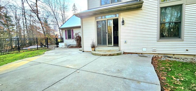 view of exterior entry featuring a patio