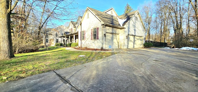 view of side of property with a garage and a yard