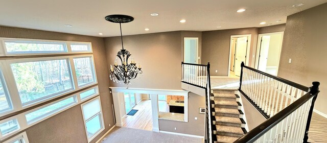 stairway featuring a notable chandelier and carpet floors