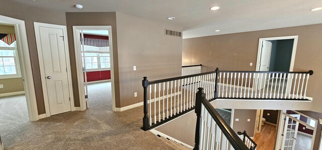 corridor featuring carpet floors and a wealth of natural light