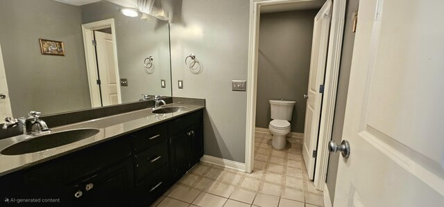 bathroom featuring tile patterned floors, vanity, and toilet