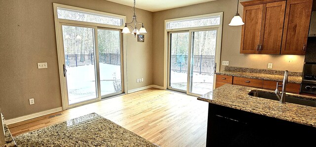 doorway featuring light hardwood / wood-style floors, a wealth of natural light, and sink