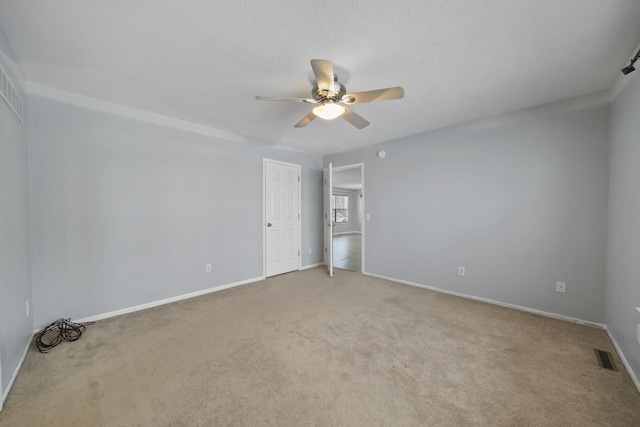 carpeted empty room featuring a textured ceiling and ceiling fan