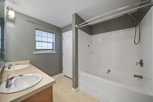 bathroom with vanity,  shower combination, and a textured ceiling