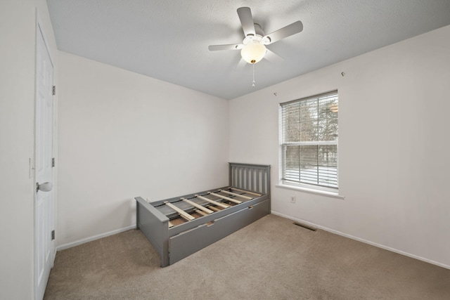 unfurnished bedroom with ceiling fan and light carpet