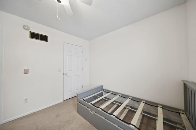 unfurnished bedroom featuring light carpet and ceiling fan