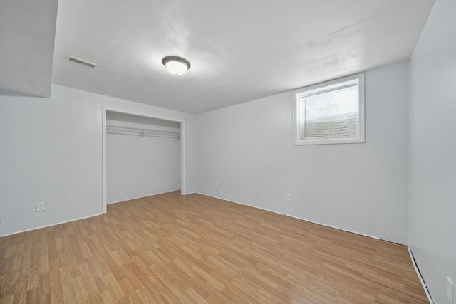 unfurnished bedroom featuring light hardwood / wood-style floors and a closet