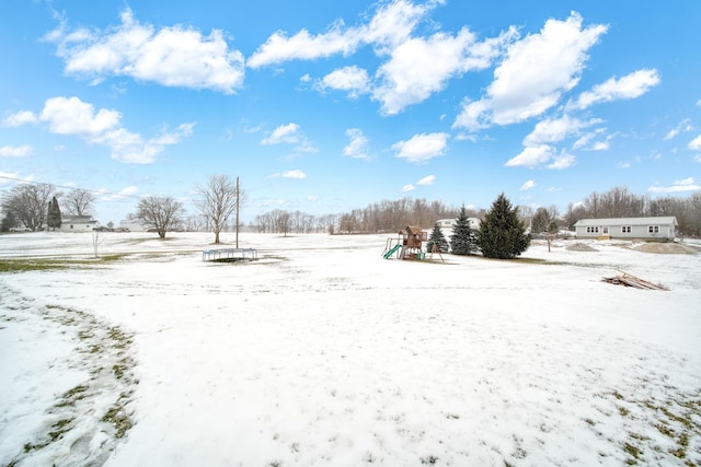 yard layered in snow with a playground