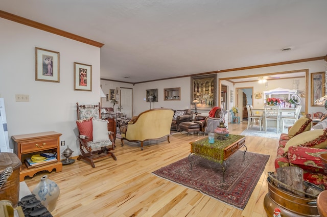 living room with wood-type flooring and ornamental molding