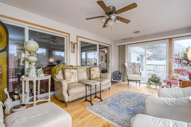 sunroom / solarium featuring ceiling fan